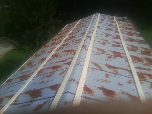 Rusted metal roof panels with new wood purlins before replacement — Storm Damage Roof Repair in Fallston by Roofing Brothers